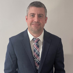 Kristofer Graham CPA, headshot, smiling in suit and tie.